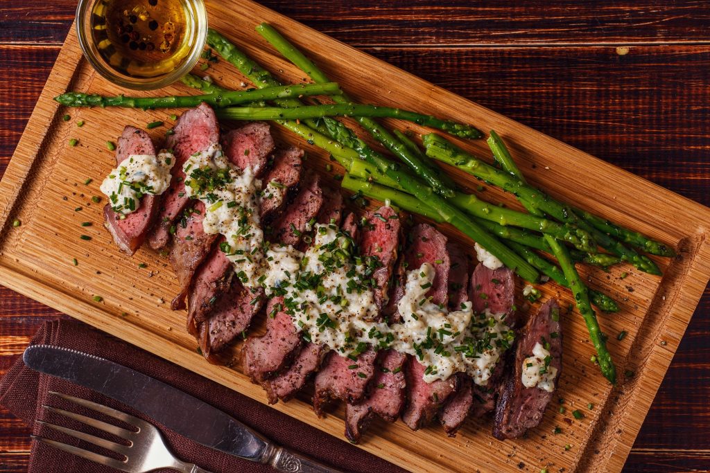 Orange County Restaurant Week preview dish featuring sliced steak along with grilled asparagus.