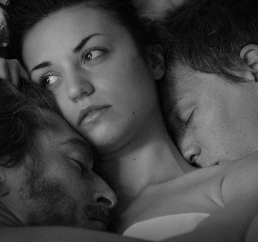 Neyssan Falahi, Cristina Rambaldi and Mattia Minasi kissing in bed in the movie “Show Me What You Got.”